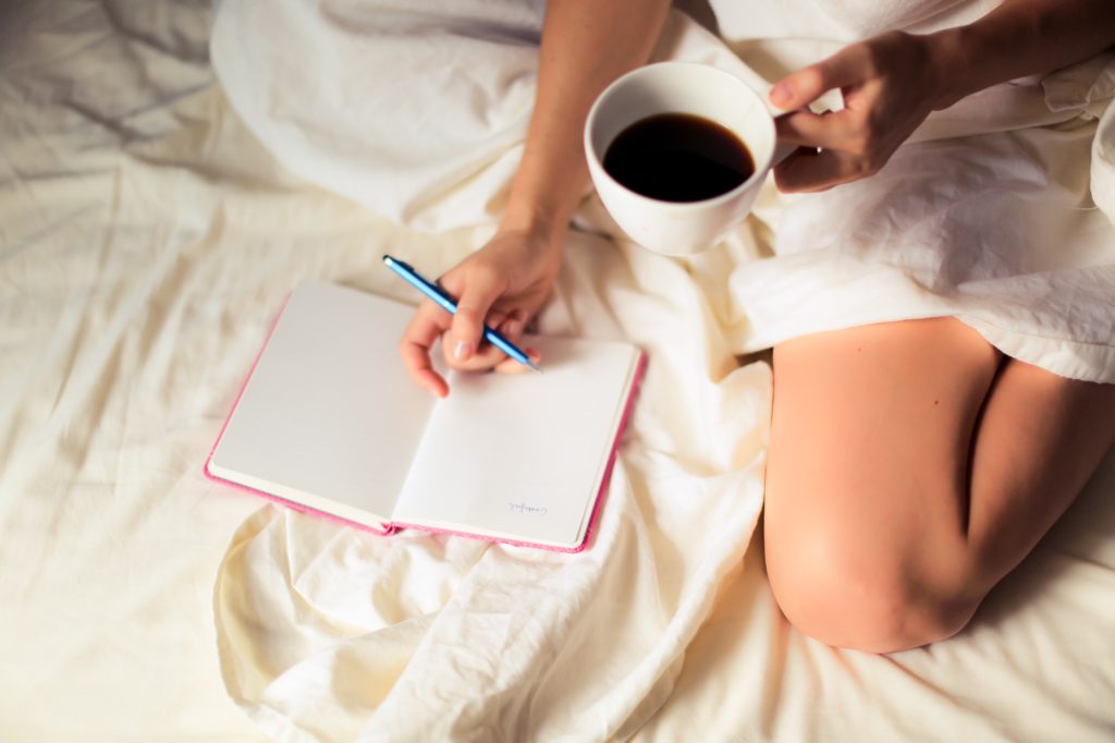 Journaling in bed with coffee 